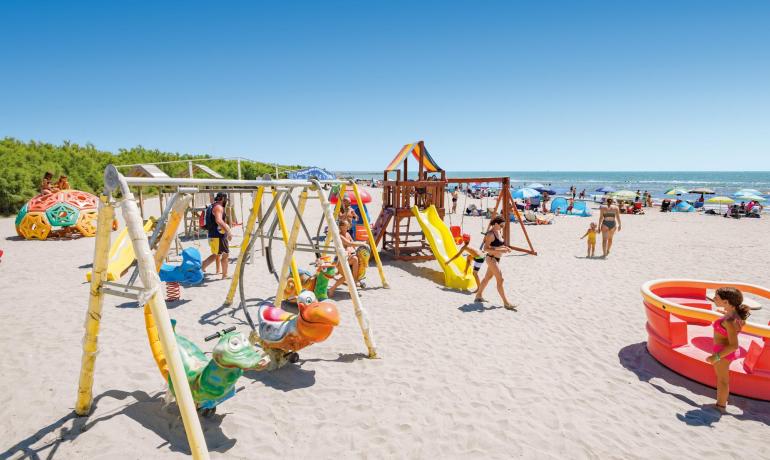 Beach with playground for children and families by the sea.